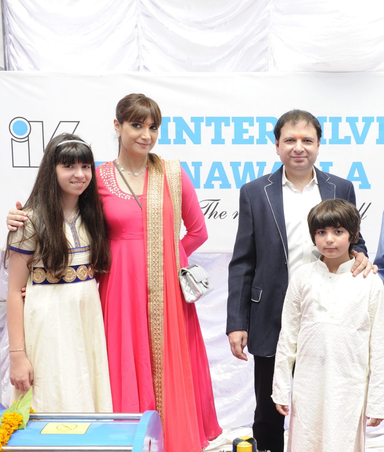 ohan Poonawalla with family at a public event photo backdrop