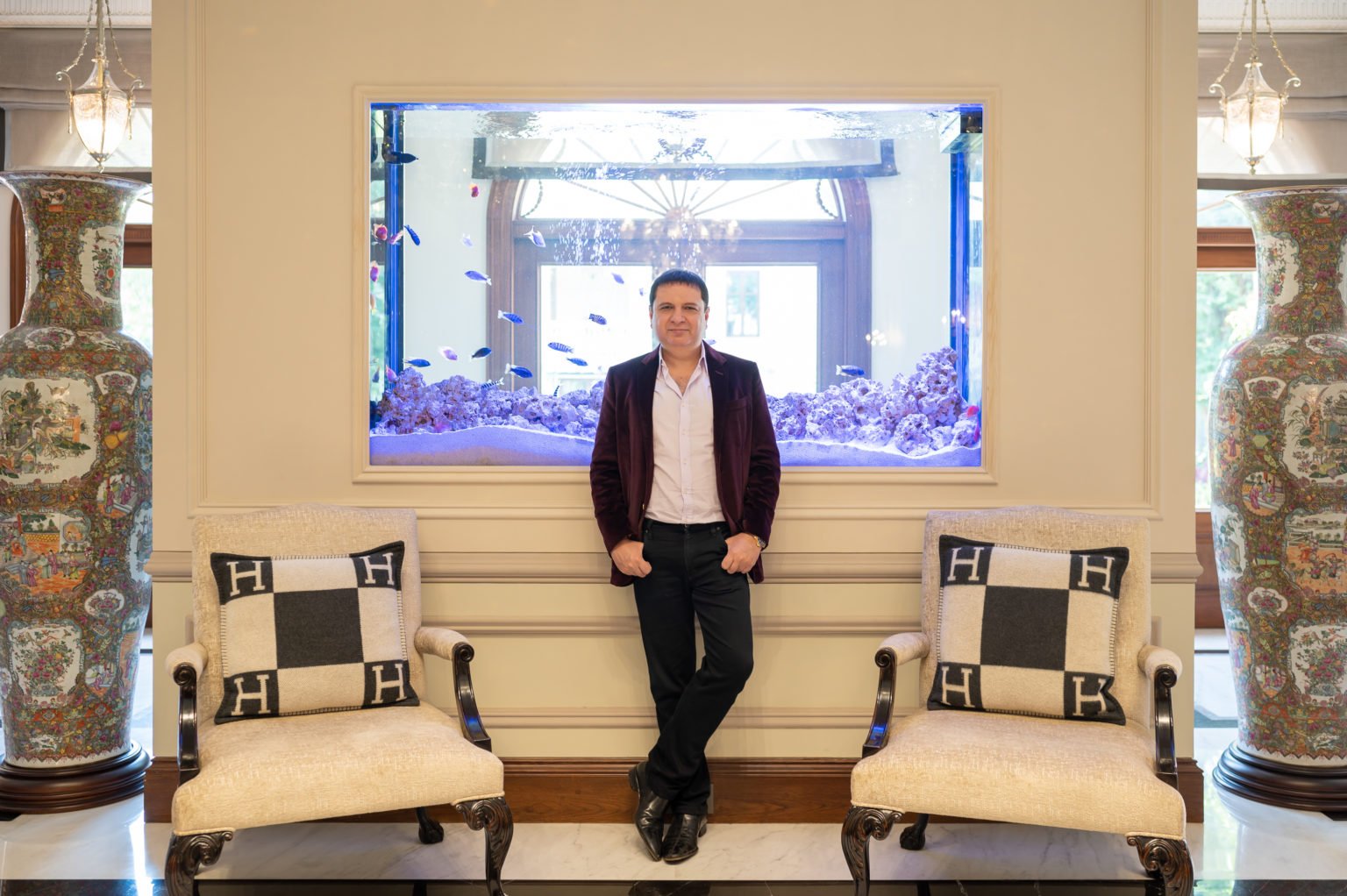 Yohan Poonawalla in luxury interior with large aquarium